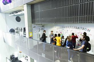 Crowd gathered around a decentralisation poster at MozFest