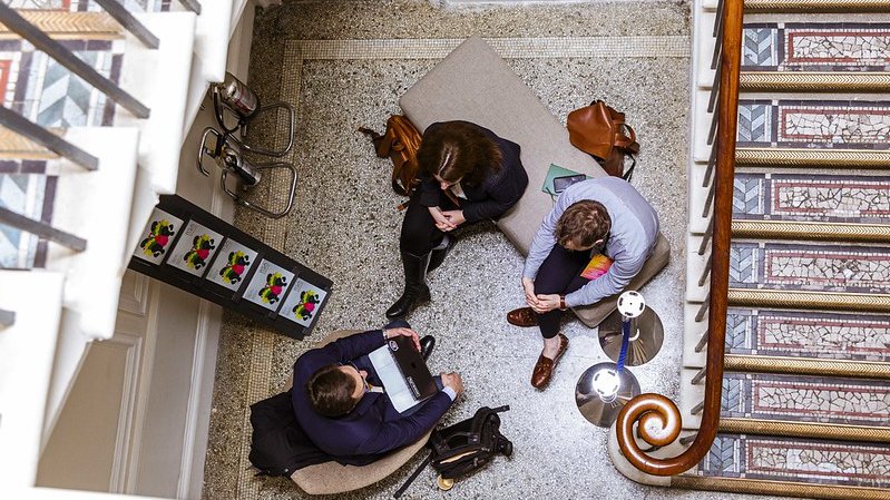 A group of three people sitting on the floor