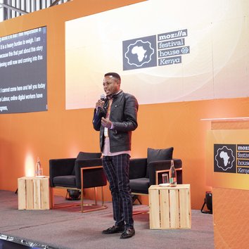 A person giving a talk on a stage