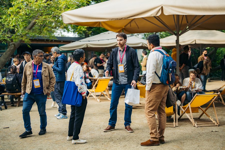 A group of people having a conversation at a conference