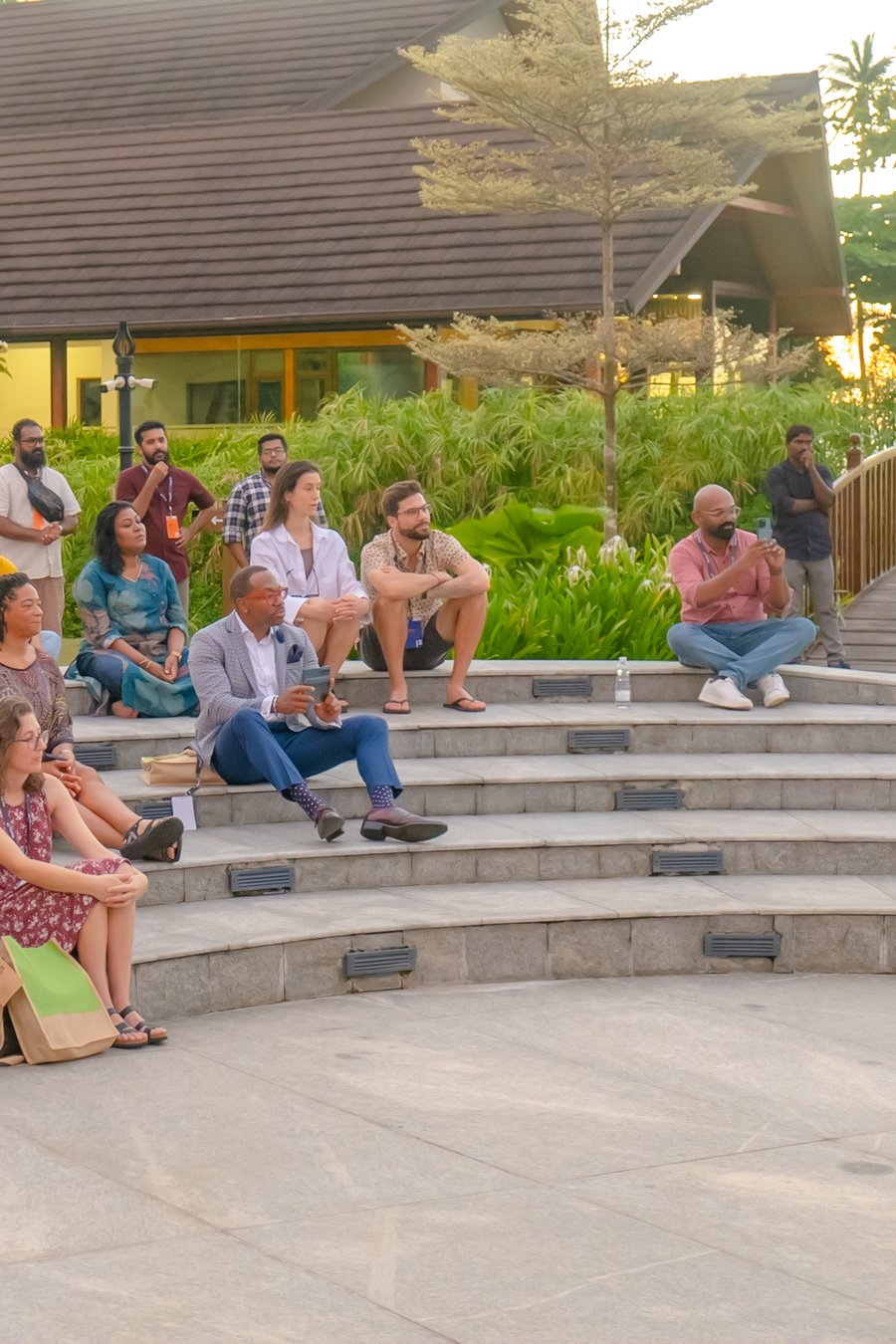 Group of 20 people sitting outside 