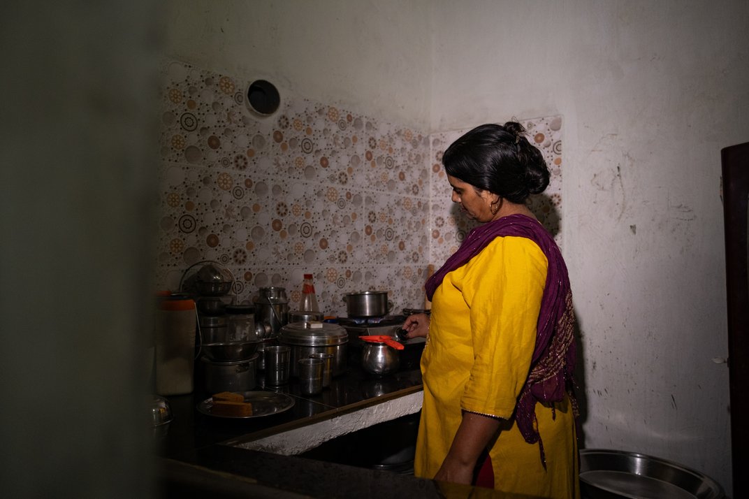 Mamta Devi cooking for her family.