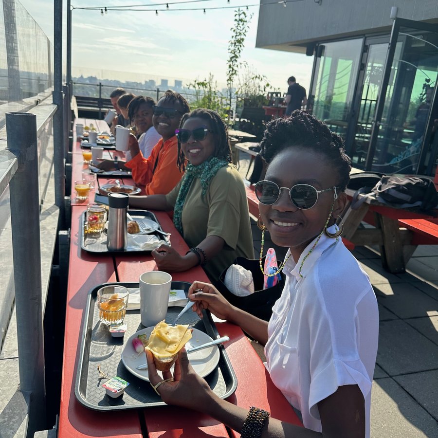 Mozilla alumni sit at a table smiling