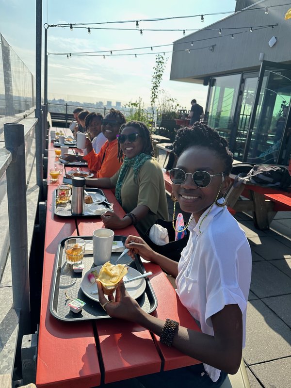 Mozilla alumi sit at a table smiling