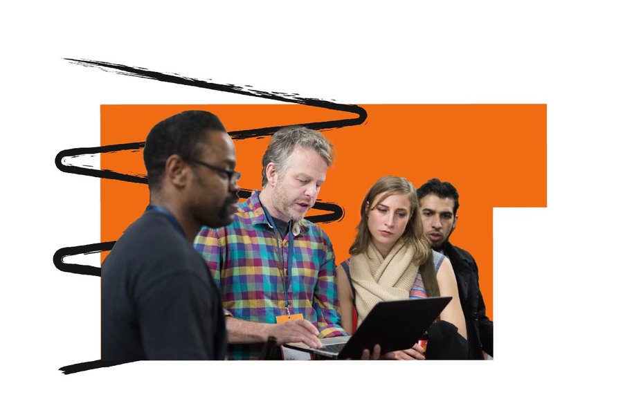 Four people looking at a computer screen against an orange shape background with a black hand drawn zig zag squiggle