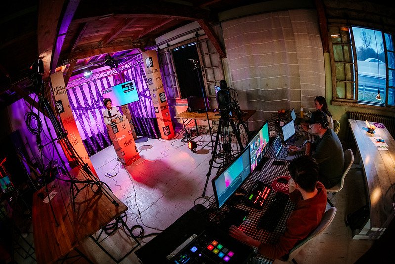 An aerial photograph of a film tudio recording someone standing at a podium