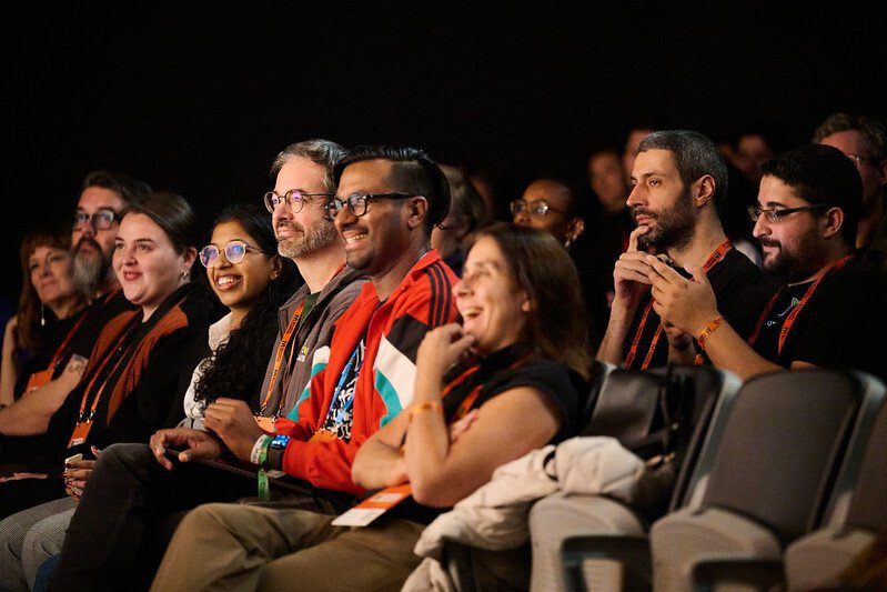 A group of incubator grantees watching a presentation