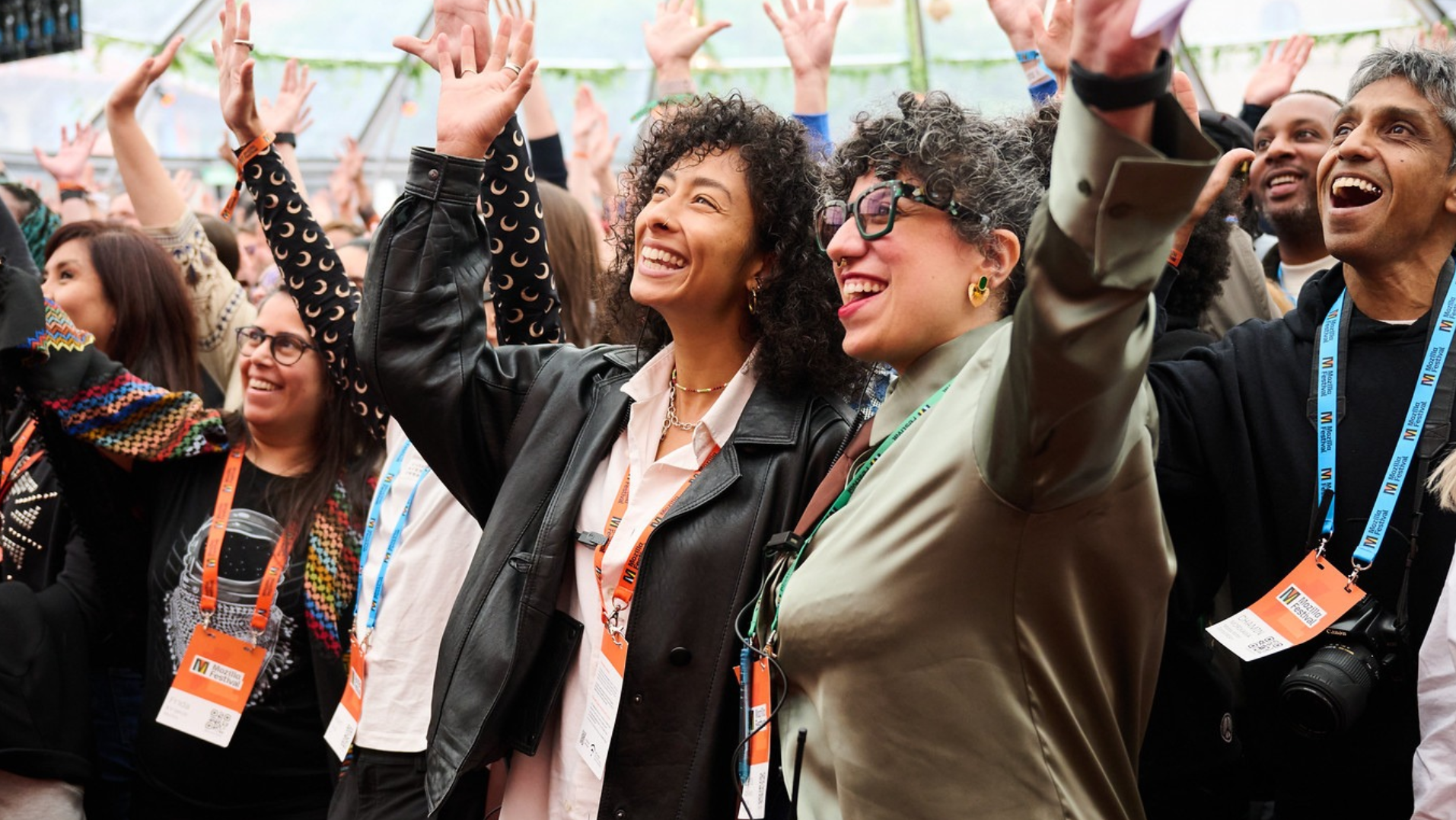 MozFest attendees waving their hands and smiling