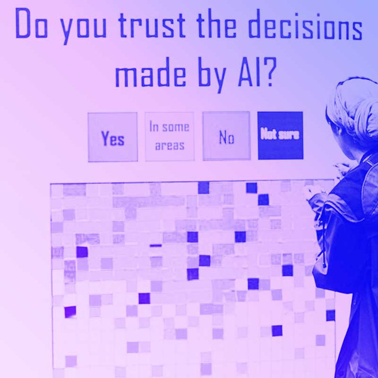A person stands in front of an installation at MozFest where people place a sticky note of a certain color depending if they agree with the statement Do you trust the decisions made by AI