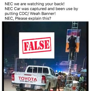 Fact-checked image of NEC Upper Nimba Magistrate putting up a pro-government poster, from FactCheckLiberia.