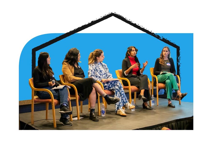 Five people sitting on a stage in a panel style converseing against a blue shape background and an animated black hand drawn scribble