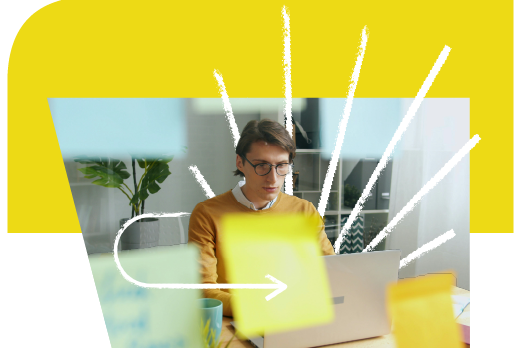 Man with glasses looking at his laptop