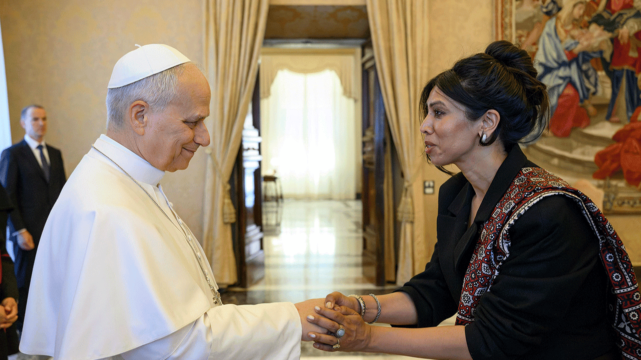Nabiha Syed holds hands with Pope Leo XIV
