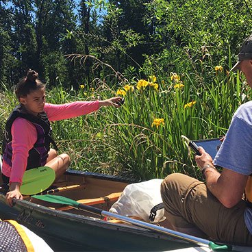 Photo of people in a canoe in the wetlands