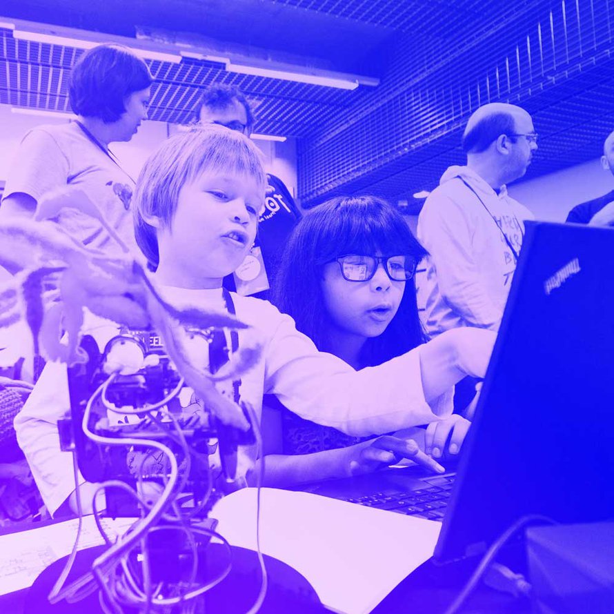 Two young participants, working together on a laptop at MozFest